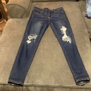 Dark wash American Eagle jeans. With some distress.
